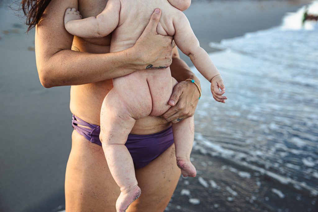 Breastfeeding baby on the beach